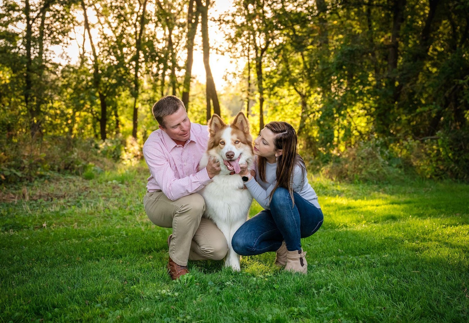Man embracing his dog during a dog and owner photography session at Hoyt Park in Wauwatosa, Wisconsin. 