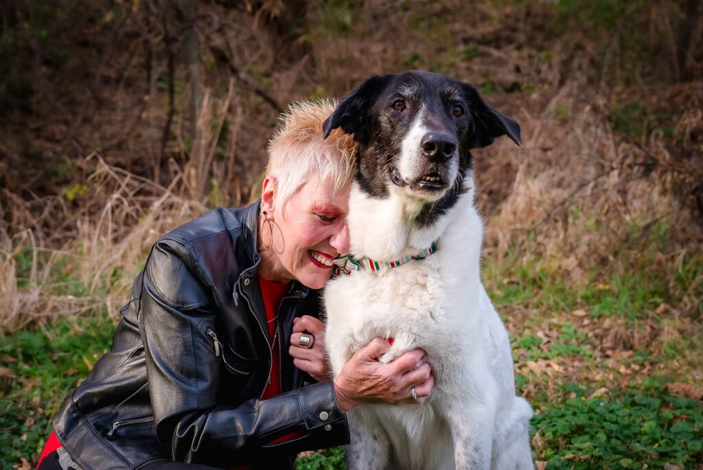 woman leaning into her dog during a senior dog photography session 